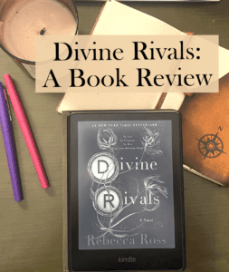 Title is Divine Rivals: A Book Review with a flatlay of the book, notebook, and pens surrounding the book.